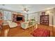 A cozy living room with hardwood floors, built-in shelving, plantation shutters, and comfortable seating at 513 Legacy Park Dr, Casselberry, FL 32707