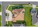 Expansive home on a lush green corner lot, highlighted with an aerial view showcasing roof and landscaping at 5339 Pond Crossing Pl, Leesburg, FL 34748
