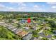 Beautiful aerial view of a home near a serene lake and lush greenery in a quiet neighborhood at 5339 Pond Crossing Pl, Leesburg, FL 34748