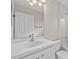 A full bathroom with a white sink, cabinets, toilet, mirror and tiled bathtub-shower combination at 5339 Pond Crossing Pl, Leesburg, FL 34748