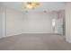 Carpeted bedroom with a ceiling fan and access to other rooms through the entry door at 5339 Pond Crossing Pl, Leesburg, FL 34748