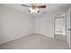 Carpeted bedroom has a ceiling fan and a double closet at 5339 Pond Crossing Pl, Leesburg, FL 34748