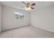 This carpeted bedroom has neutral walls, and a bright window at 5339 Pond Crossing Pl, Leesburg, FL 34748