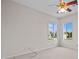 This carpeted bedroom has two bright windows with neutral paint at 5339 Pond Crossing Pl, Leesburg, FL 34748
