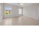 Bright, neutral bedroom with tile flooring and windows providing natural light at 5339 Pond Crossing Pl, Leesburg, FL 34748