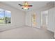 The spacious carpeted bedroom features a ceiling fan and a patio door at 5339 Pond Crossing Pl, Leesburg, FL 34748