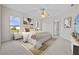 Cozy bedroom featuring a comfortable bed, natural light, and ceiling fan at 5339 Pond Crossing Pl, Leesburg, FL 34748