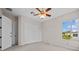 This carpeted bedroom features a double closet and window at 5339 Pond Crossing Pl, Leesburg, FL 34748