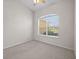 Simple bedroom with neutral paint and carpet, and a window with blinds at 5339 Pond Crossing Pl, Leesburg, FL 34748