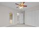 Bedroom featuring a ceiling fan, patio door, and double closets at 5339 Pond Crossing Pl, Leesburg, FL 34748