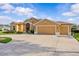 Charming home featuring a three-car garage and lush landscaping at 5339 Pond Crossing Pl, Leesburg, FL 34748