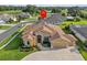 Inviting single-story home with a well-manicured lawn, mature landscaping, and a two-car garage at 5339 Pond Crossing Pl, Leesburg, FL 34748