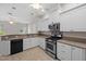 Modern kitchen with stainless steel appliances and open layout at 5339 Pond Crossing Pl, Leesburg, FL 34748