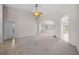Large living area with archways, carpet, and neutral paint, creating a blank canvas at 5339 Pond Crossing Pl, Leesburg, FL 34748