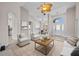 Bright living room with high ceilings, neutral colors, and archways to other rooms at 5339 Pond Crossing Pl, Leesburg, FL 34748