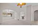 Spacious living area with an archway overlooking a dining space and featuring neutral tones at 5339 Pond Crossing Pl, Leesburg, FL 34748