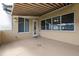 Covered patio with a retractable awning and access to the home's interior at 5339 Pond Crossing Pl, Leesburg, FL 34748