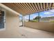 This covered patio features a ceiling fan and leads to the exterior through a glass door at 5339 Pond Crossing Pl, Leesburg, FL 34748