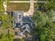 Aerial view showcases solar panels on roof with a gazebo in the backyard and surrounding lush greenery at 604 Thrush Ave, Longwood, FL 32750