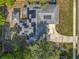 Aerial view of a home with a driveway and solar panels on roof, providing an energy-efficient and stylish property at 604 Thrush Ave, Longwood, FL 32750