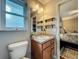 Bright bathroom features a granite vanity, ample lighting and storage space, and access to the main bedroom at 604 Thrush Ave, Longwood, FL 32750