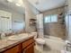 Tiled bathroom with vanity, toilet, shower, and bath combination at 604 Thrush Ave, Longwood, FL 32750