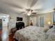 Spacious bedroom showcases hardwood floors, ceiling fan, and access to a walk-in closet and an en-suite bathroom at 604 Thrush Ave, Longwood, FL 32750