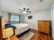 Bright bedroom featuring a ceiling fan, TV, and wood-look flooring at 604 Thrush Ave, Longwood, FL 32750
