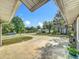 Exterior view from the covered porch showcasing the driveway and neighborhood with pond views at 604 Thrush Ave, Longwood, FL 32750