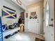 Inviting foyer with tile flooring, decorated walls, and a door leading to the laundry room at 604 Thrush Ave, Longwood, FL 32750