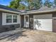 Close-up of the front door featuring a white door with decorative wreath and adjacent garage at 604 Thrush Ave, Longwood, FL 32750
