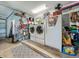 Garage with washer, dryer, and additional storage shelving at 604 Thrush Ave, Longwood, FL 32750