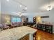 Kitchen island with countertop seating overlooks the living area, stainless steel appliances, and hardwood floors at 604 Thrush Ave, Longwood, FL 32750