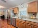Open kitchen with stainless steel appliances and light wood cabinets at 604 Thrush Ave, Longwood, FL 32750