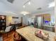 Kitchen island, stainless steel appliances, and access to living room area create open living at 604 Thrush Ave, Longwood, FL 32750