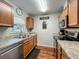 Well-lit kitchen with stainless steel appliances, light wood cabinets, and a view from window at 604 Thrush Ave, Longwood, FL 32750
