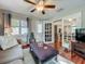 Comfortable living room boasts hardwood floors and seamless transition to kitchen through beautiful glass paneled doors at 604 Thrush Ave, Longwood, FL 32750