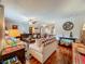 Cozy living room featuring wood floors and comfortable seating with a view to the dining area at 604 Thrush Ave, Longwood, FL 32750
