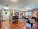 Open-concept living space features hardwood floors, kitchen access, and comfortable seating at 604 Thrush Ave, Longwood, FL 32750