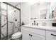 Bathroom with a modern vanity, marble-look shower with sleek black trim, and matte black fixtures at 692 Gaslight Dr, South Daytona, FL 32119