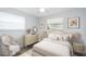Comfortable bedroom featuring a neutral color palette, a decorative dresser and matching nightstand at 692 Gaslight Dr, South Daytona, FL 32119