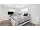 Cozy bedroom featuring a ceiling fan and decorative black and white patterned bedding at 692 Gaslight Dr, South Daytona, FL 32119