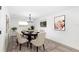 Bright dining room features stylish chandelier, wood table with seating for six and natural light at 692 Gaslight Dr, South Daytona, FL 32119