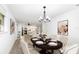 Elegant dining room with a chandelier, and views of the kitchen area at 692 Gaslight Dr, South Daytona, FL 32119
