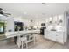 Modern kitchen featuring bright white cabinets, black appliances, and a large island at 692 Gaslight Dr, South Daytona, FL 32119