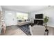 Living room features a white couch, and a dark wood entertainment center at 692 Gaslight Dr, South Daytona, FL 32119