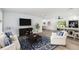 Bright living room with white furniture, a large rug, and an open floor plan at 692 Gaslight Dr, South Daytona, FL 32119