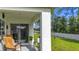 Spacious covered patio with seating area and view of green lawn at 7161 Sw 135Th Pl, Ocala, FL 34473