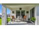 Covered back patio with seating area, table, and outdoor decor at 7161 Sw 135Th Pl, Ocala, FL 34473