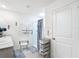 Bright bathroom featuring double sinks, decorative blue accents, and a convenient accessible shower chair at 7161 Sw 135Th Pl, Ocala, FL 34473